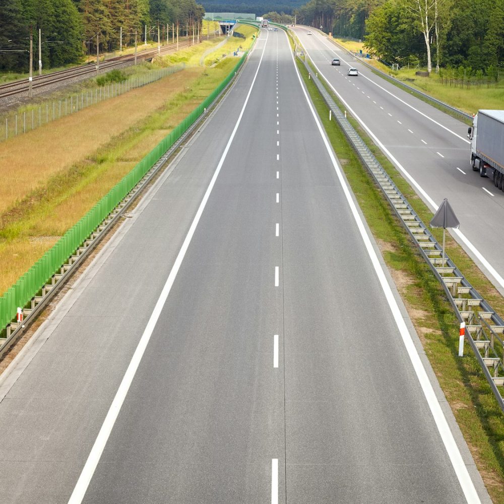 Panoramic picture of a lorry on almost empty highway